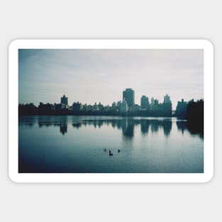 Film photo of Central Park, New York City, with its lake and surrounded buildings Sticker